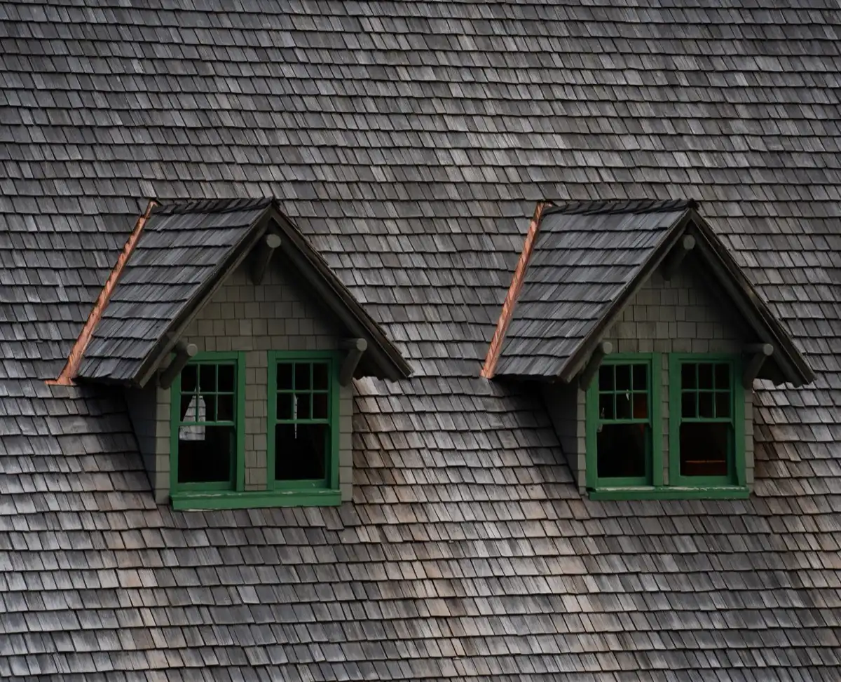 Dormers on a shingle roof in Saginaw, MI, where step flashing and kickout flashing carry water past the walls